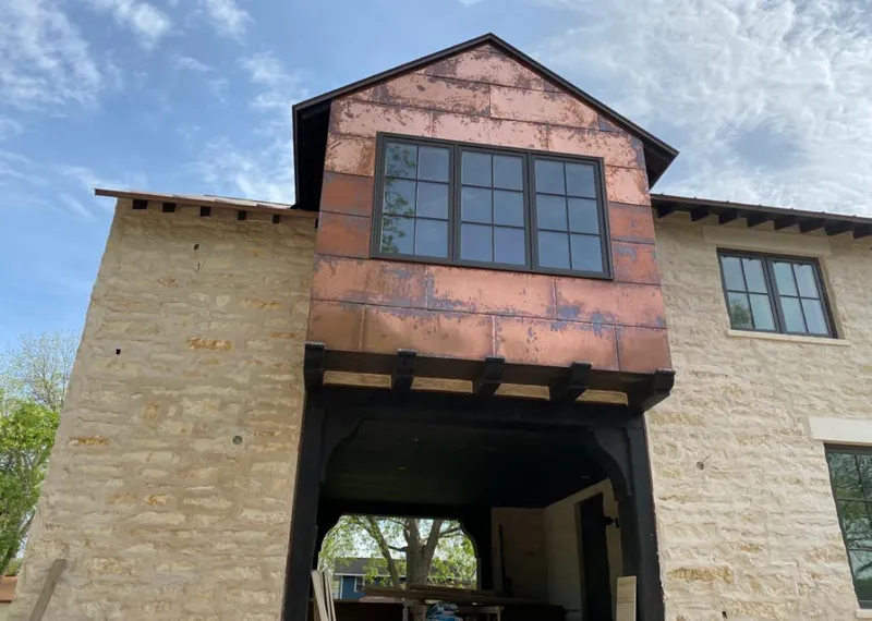 Copper metal panel facade on a stone building for Skylight Installation in Penfield